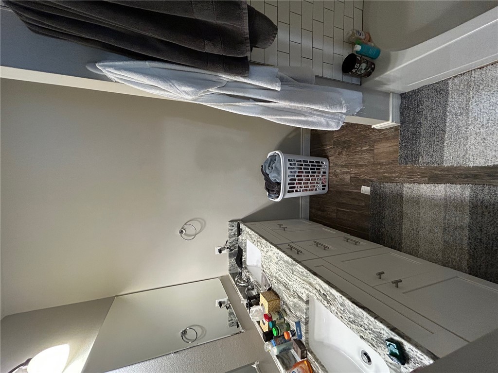 632 Clay Street, Unit B Bryan, TX 77801 - Photo 10 of 16 a bathroom with a sink and a mirror