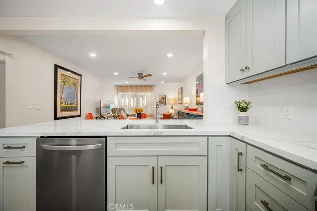 a living room with furniture a rug and a flat screen tv