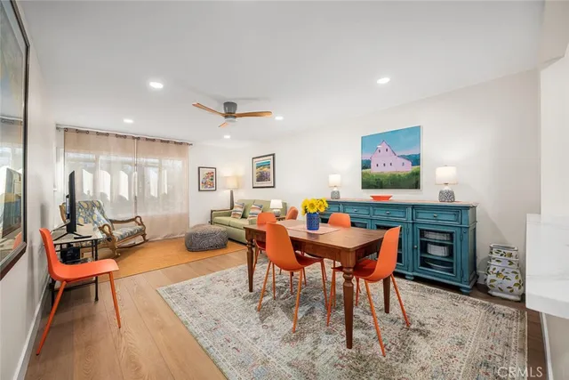 a kitchen with stainless steel appliances dining table and chairs