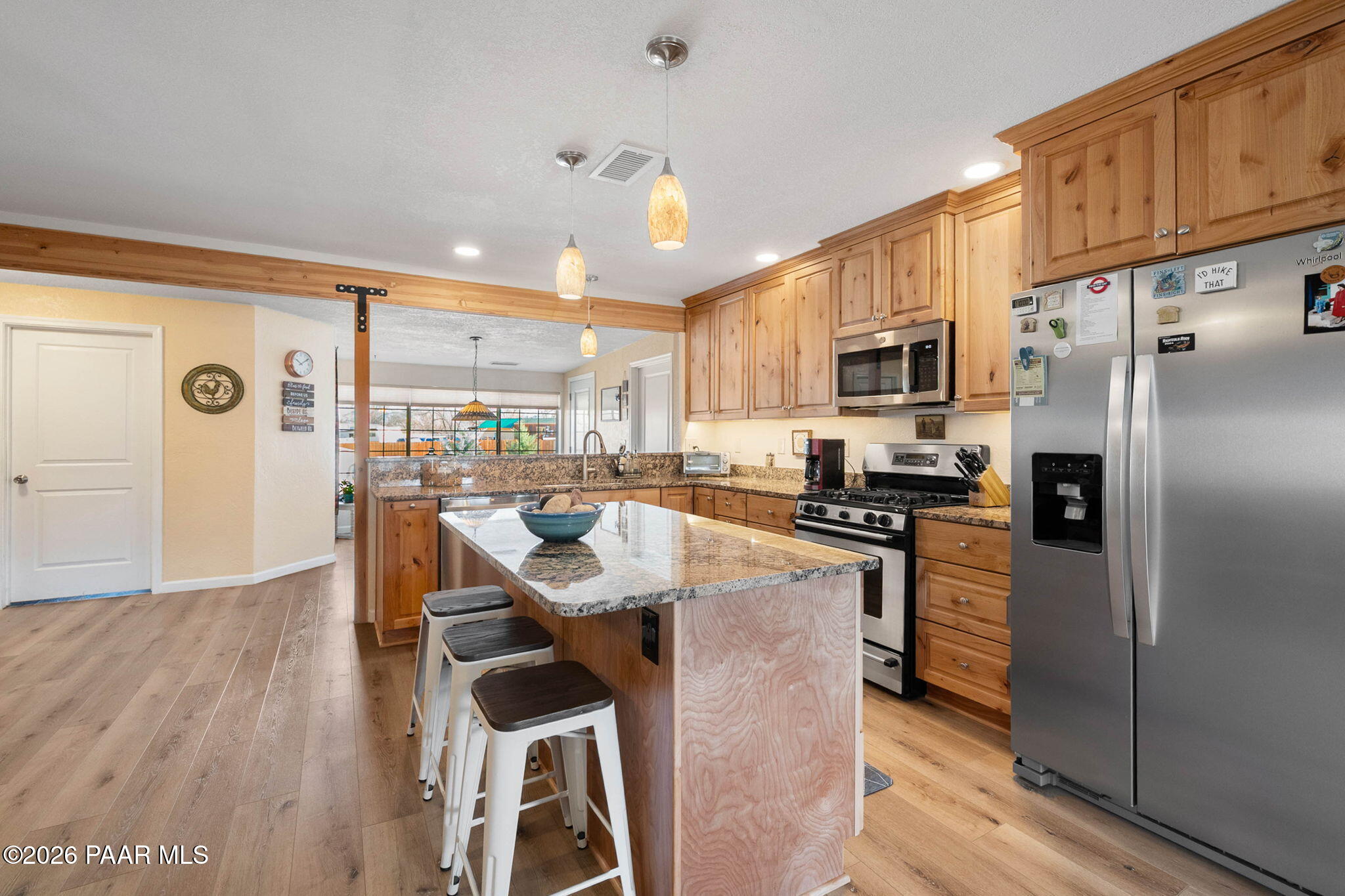 1326 East Ben Road Chino Valley, AZ 86323 - Photo 11 of 51 a kitchen with stainless steel appliances granite countertop a refrigerator a stove top oven a sink dishwasher and white cabinets with wooden floor