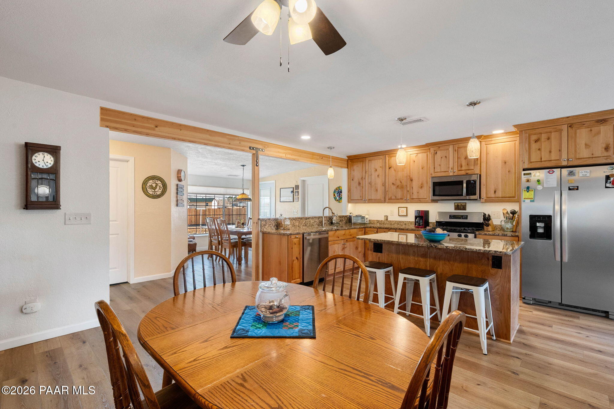 1326 East Ben Road Chino Valley, AZ 86323 - Photo 10 of 51 a view of a dining room with furniture a chandelier and wooden floor