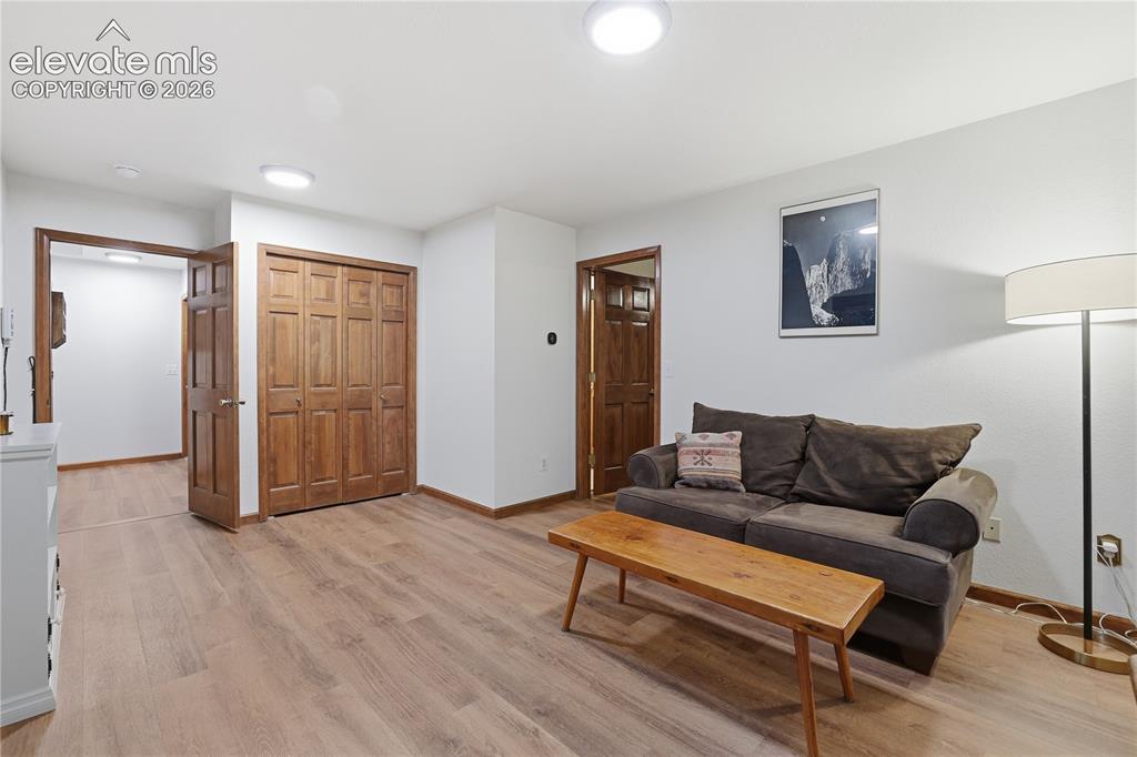 18190 Forest View Road Monument, CO 80132 - Photo 28 of 50 a living room with furniture and a wooden floor