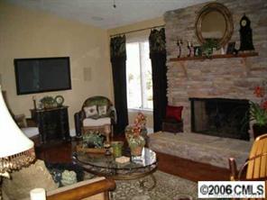 4800 Rounding Run Road Charlotte, NC 28277 - Photo 3 of 7 a living room with furniture a flat screen tv and a fireplace