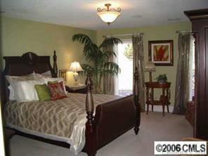 4800 Rounding Run Road Charlotte, NC 28277 - Photo 5 of 7 a bedroom with a bed lamps and table