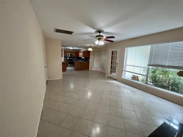 a view of an empty room with a kitchen
