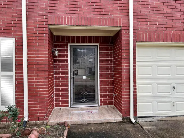 a front view of a building with a garden
