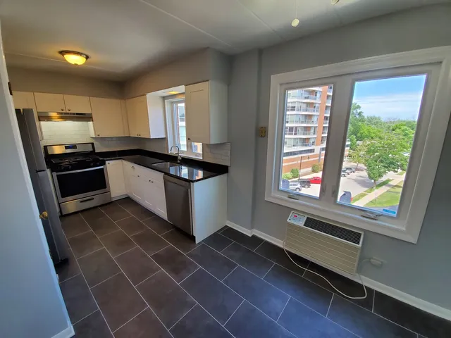 a kitchen with a stove a sink and a refrigerator