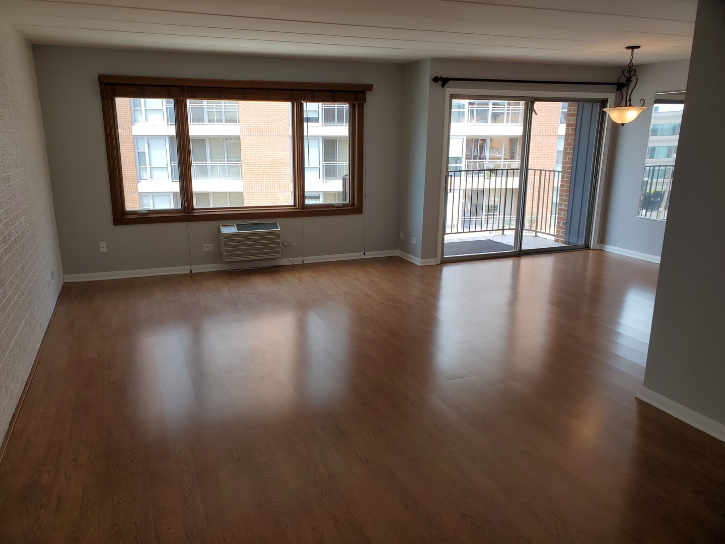 659 South River Road, Unit 5C Des Plaines, IL 60016 - Photo 3 of 24 an empty room with wooden floor and windows