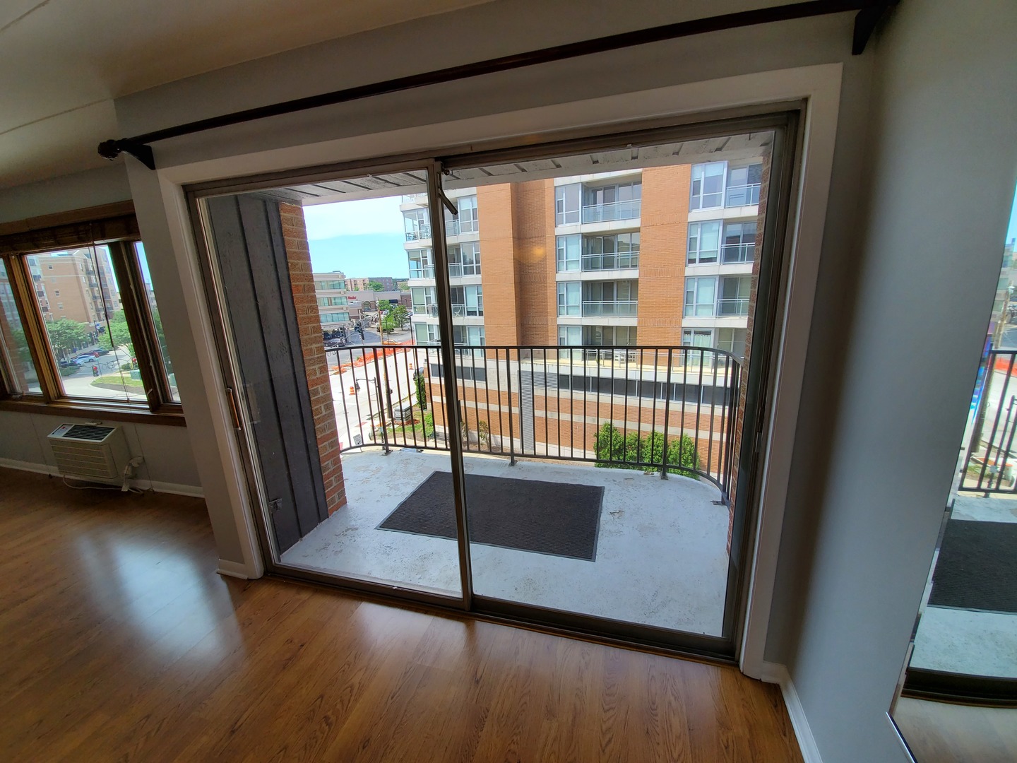 659 South River Road, Unit 5C Des Plaines, IL 60016 - Photo 5 of 24 a view of a porch with wooden floor and a floor to ceiling window