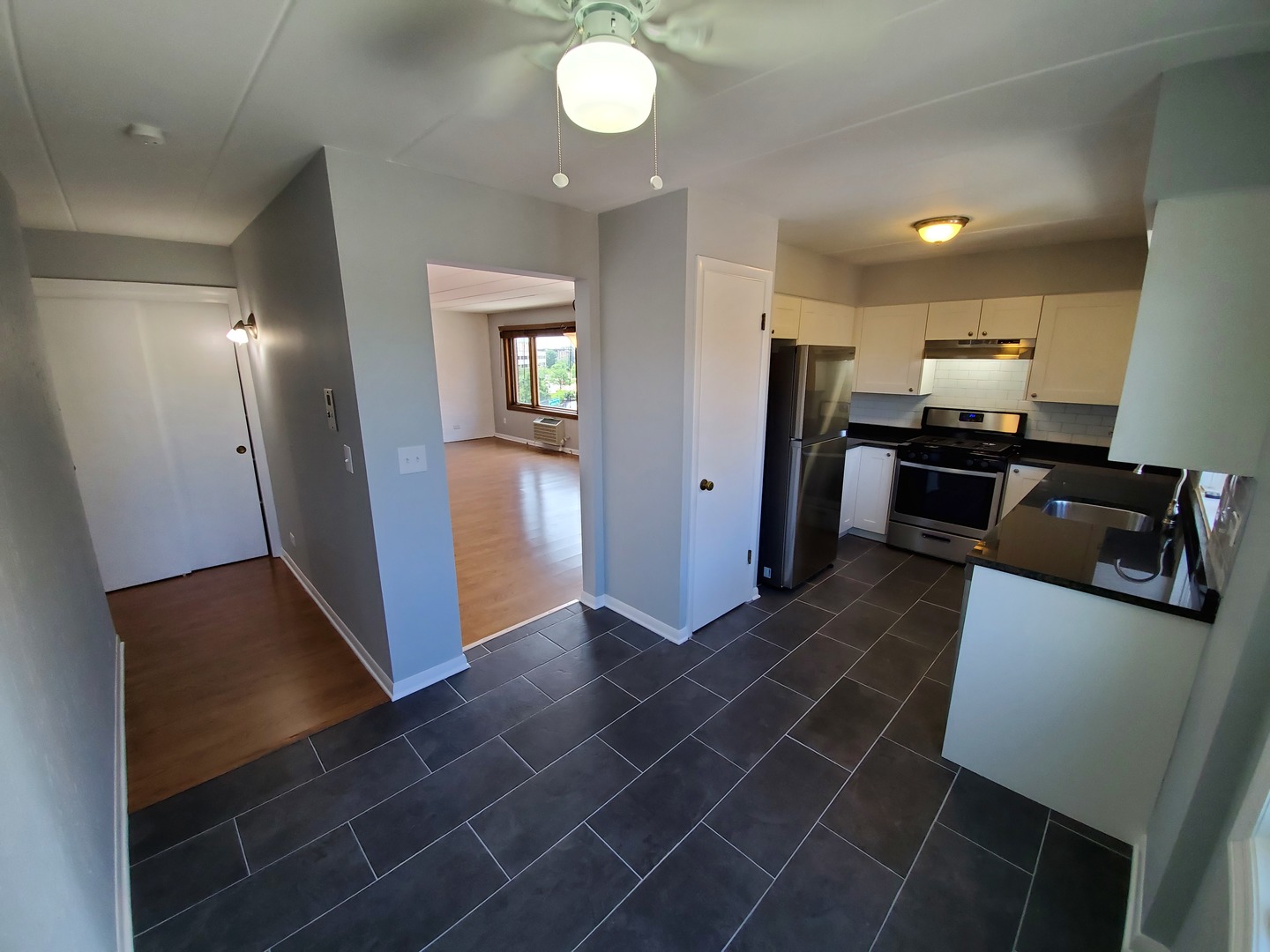 659 South River Road, Unit 5C Des Plaines, IL 60016 - Photo 10 of 24 an open kitchen with refrigerator and microwave