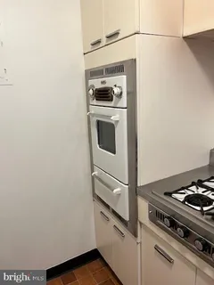 a stove top oven sitting inside of a kitchen