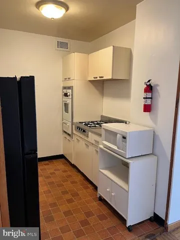 a kitchen with stainless steel appliances a refrigerator and a stove