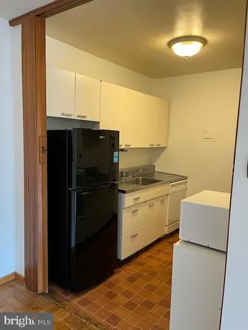 a kitchen with a refrigerator and cabinets
