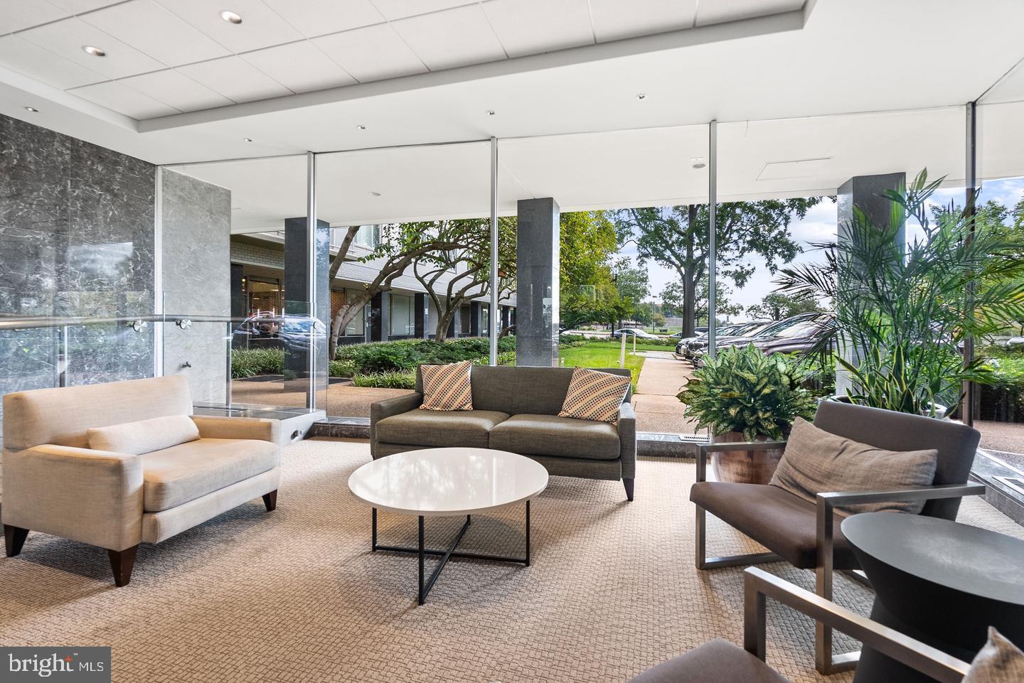 2475 Virginia Avenue Northwest, Unit 908 Washington, DC 20037 - Photo 2 of 24 Modern lounge with lush outdoor views.