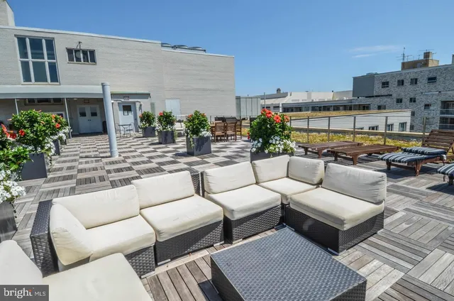 a view of a patio with couches and potted plants