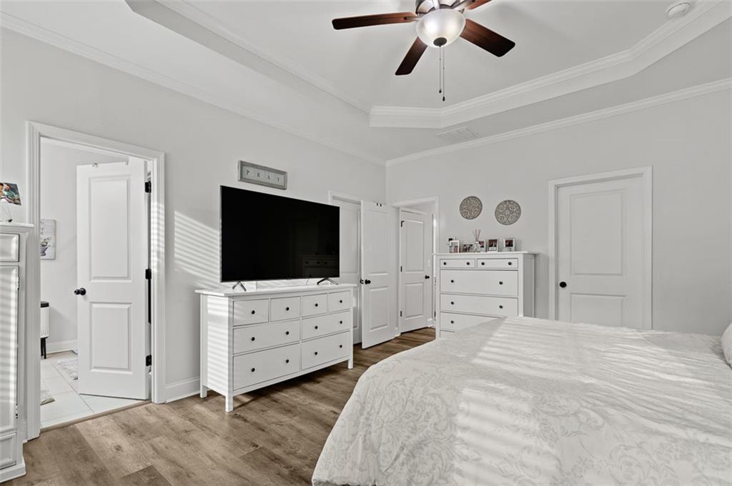 6176 Eves Way Norcross, GA 30071 - Photo 21 of 36 a view of a bedroom with bed and flat tv screen on dresser