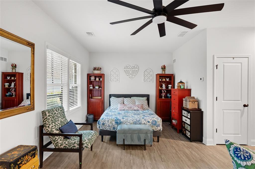 6176 Eves Way Norcross, GA 30071 - Photo 29 of 36 a bedroom with furniture and wooden floor