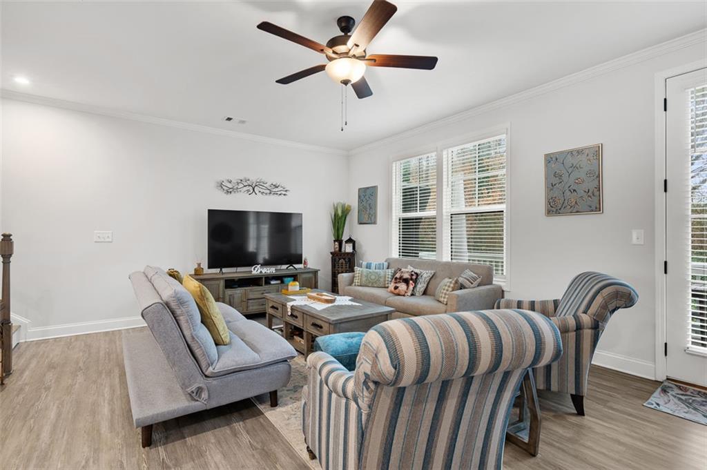 6176 Eves Way Norcross, GA 30071 - Photo 7 of 36 a living room with furniture a large window and a flat screen tv