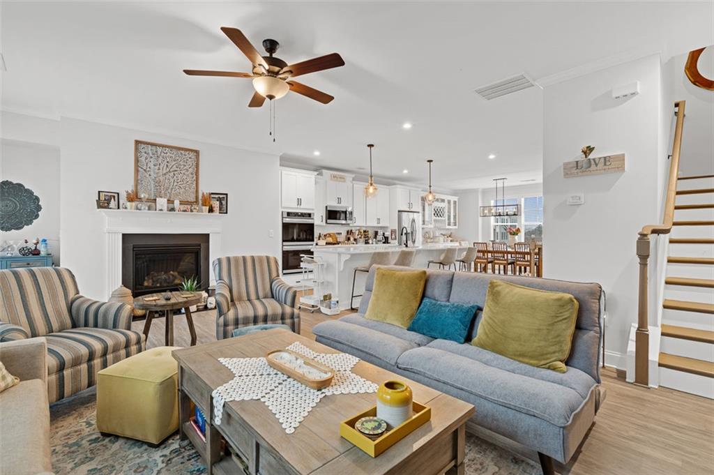 6176 Eves Way Norcross, GA 30071 - Photo 9 of 36 a living room with furniture kitchen view and a fireplace