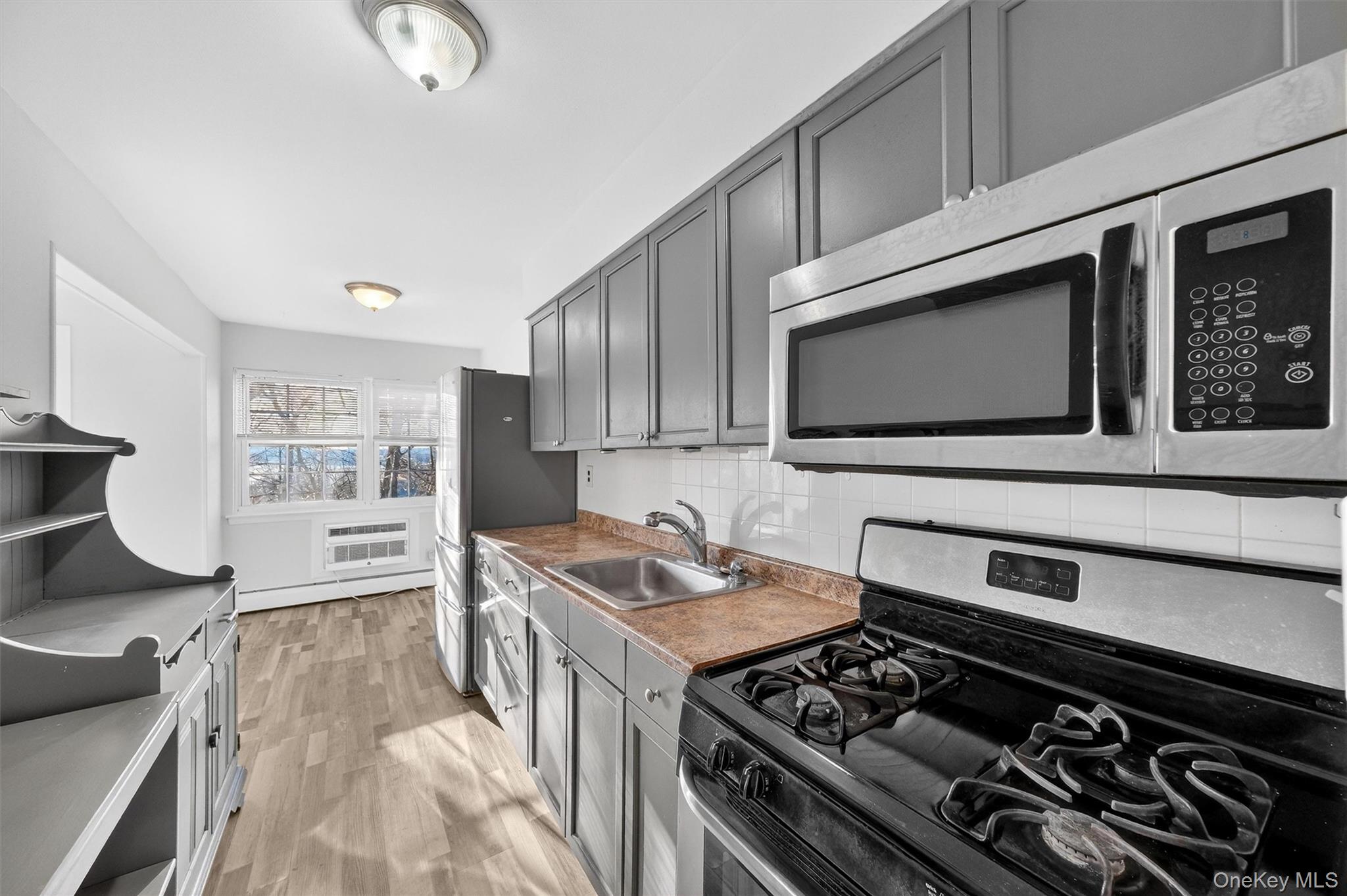 4 Colonial Road, Unit 96 Beacon, NY 12508 - Photo 2 of 17 a kitchen with a stove and a microwave