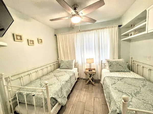 a bedroom with a large bed and a flat tv screen on a dresser