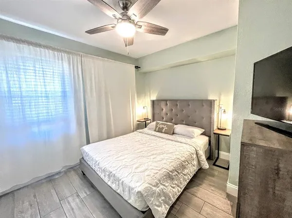 a bedroom with a bed and a window