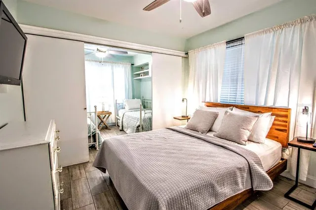 a bedroom with a bed and a flat screen tv