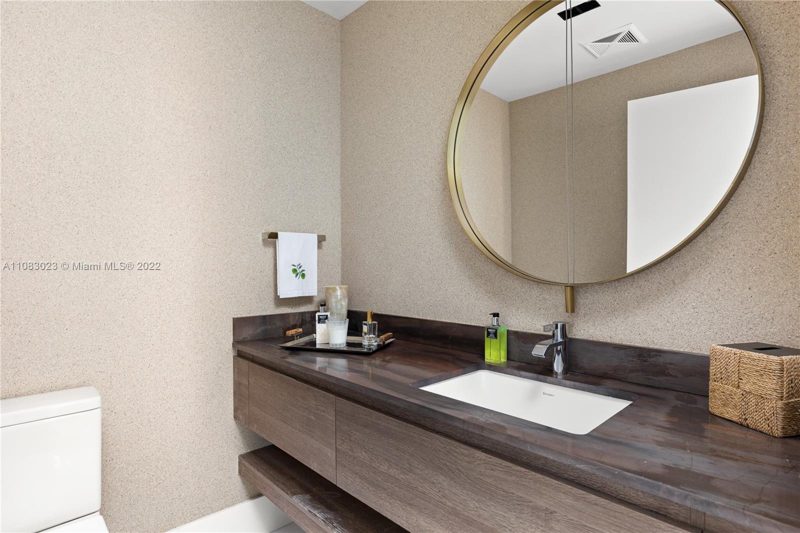 360 Ocean Drive, Unit 501S Key Biscayne, FL 33149 - Photo 16 of 40 a bathroom with a double vanity sink and a mirror
