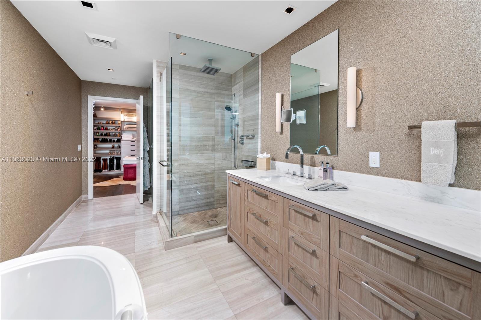 360 Ocean Drive, Unit 501S Key Biscayne, FL 33149 - Photo 20 of 40 a spacious bathroom with a granite countertop sink mirror and bathtub