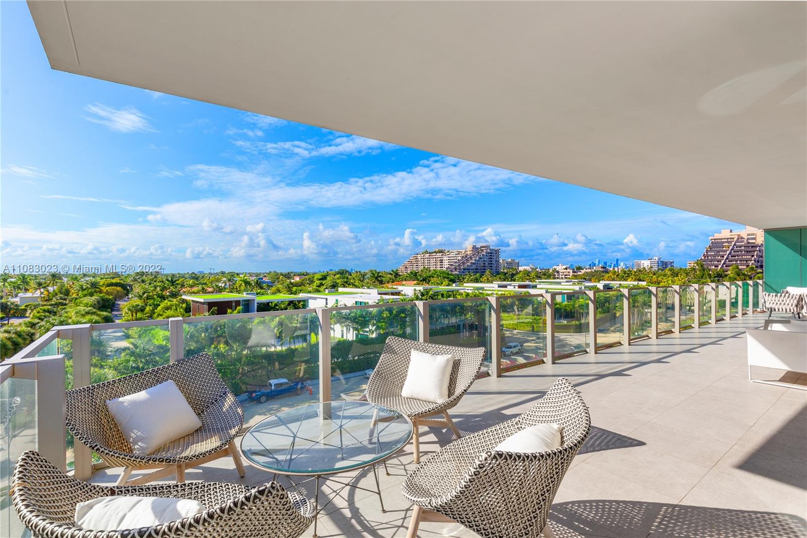 360 Ocean Drive, Unit 501S Key Biscayne, FL 33149 - Photo 30 of 40 a view of a balcony with chairs and a table