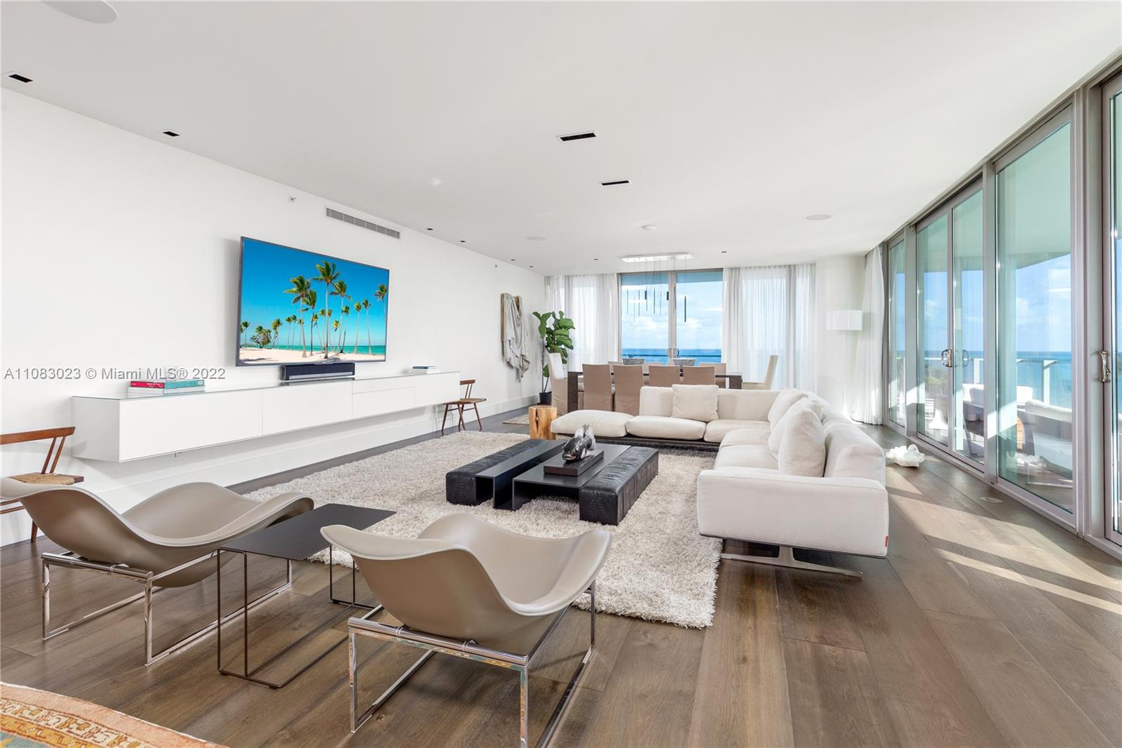 360 Ocean Drive, Unit 501S Key Biscayne, FL 33149 - Photo 6 of 40 a living room with furniture and a flat screen tv