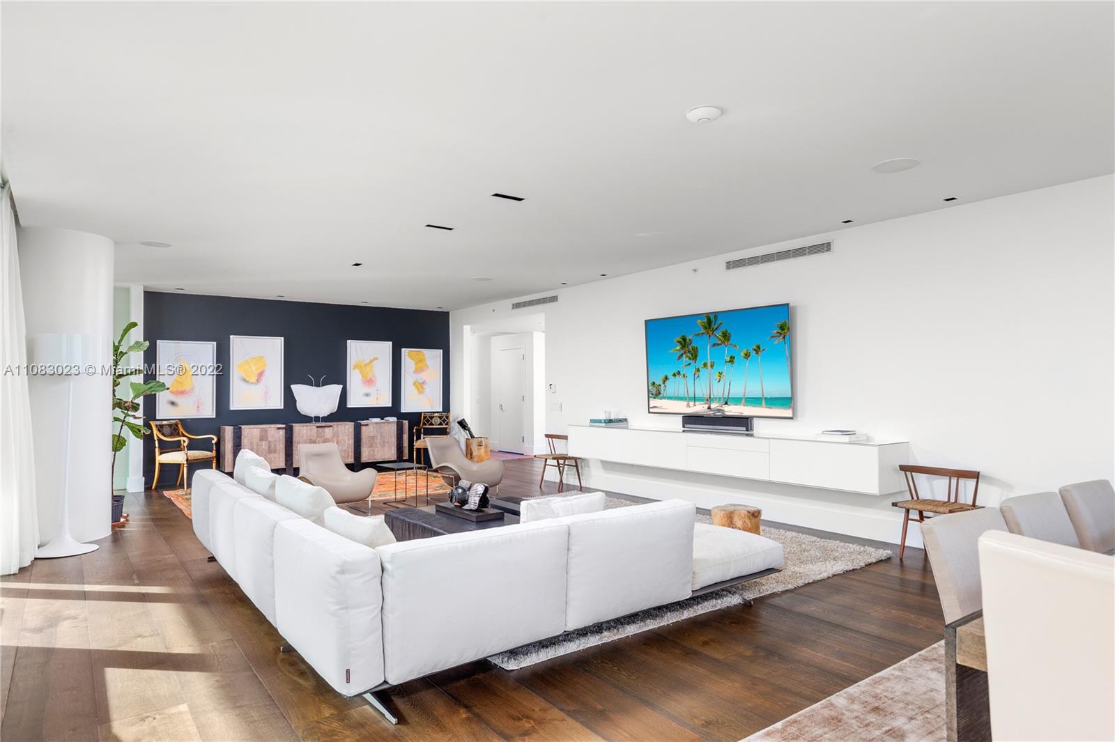 360 Ocean Drive, Unit 501S Key Biscayne, FL 33149 - Photo 9 of 40 a living room with furniture and a flat screen tv