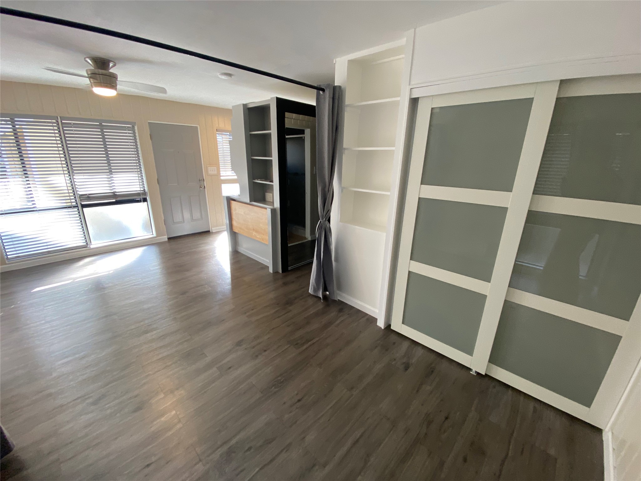3010 Fruth Street, Unit B Austin, TX 78705 - Photo 9 of 32 This naturally illuminated living space features sleek wood flooring and a modern ceiling fan.