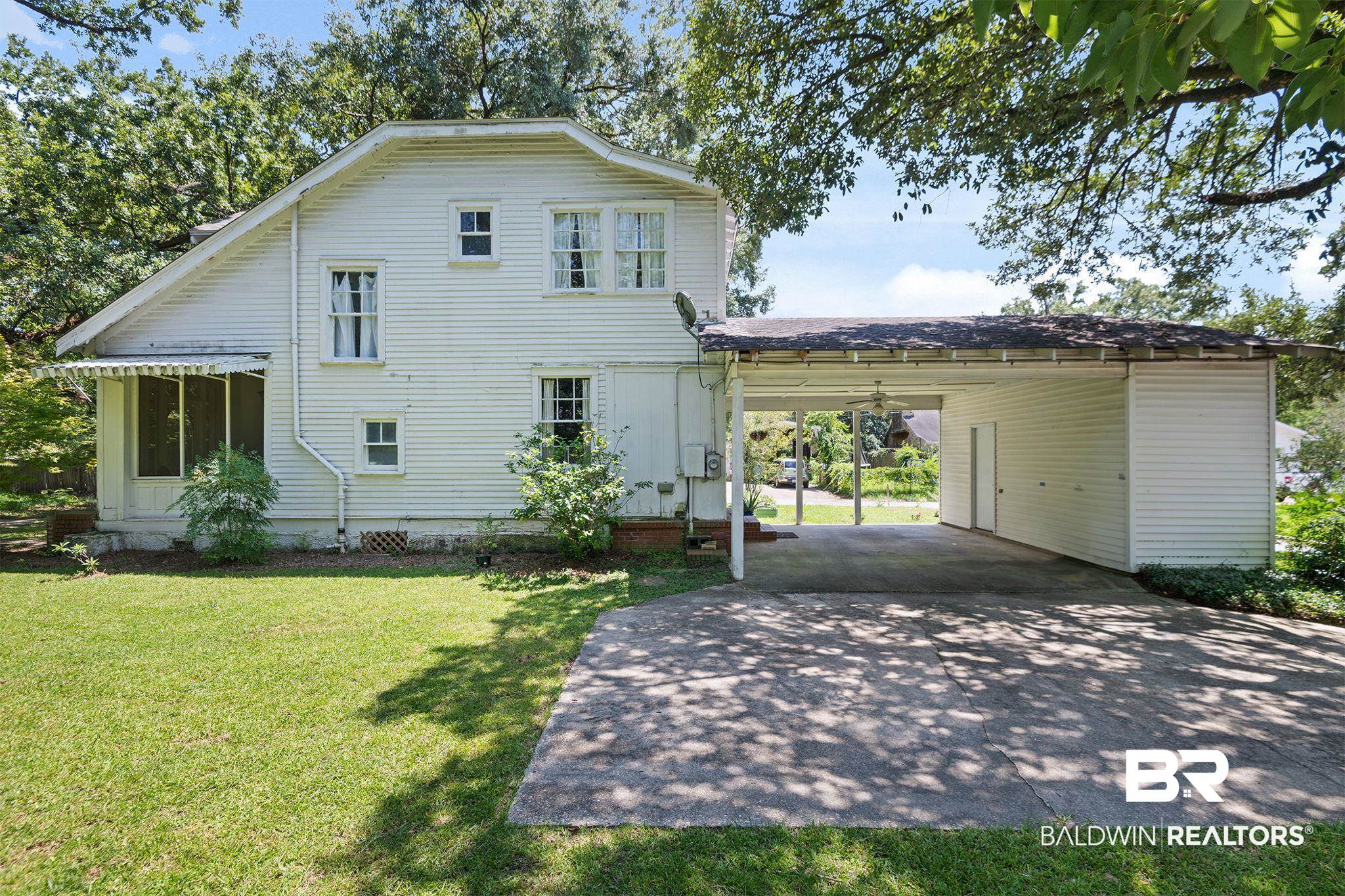 324 4th Street Mobile, AL 36611 - Photo 2 of 28 Exterior space with a carport and a front lawn
