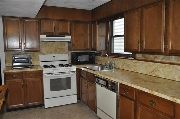 26 Mansfield Drive Wakefield, MA 01880 - Photo 16 of 26 a kitchen with a stove sink and cabinets
