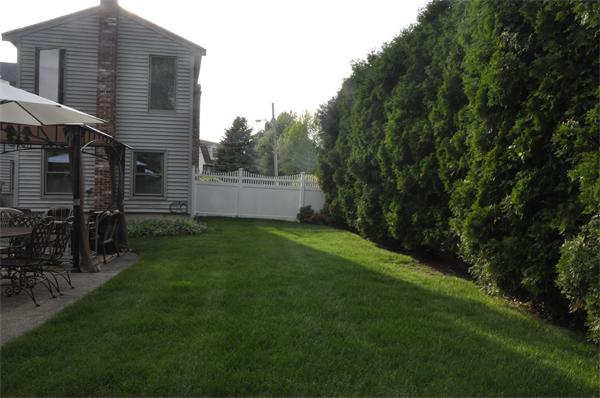 26 Mansfield Drive Wakefield, MA 01880 - Photo 24 of 26 a backyard of a house with lots of green space