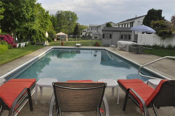 26 Mansfield Drive Wakefield, MA 01880 - Photo 25 of 26 a view of a balcony with two chairs and a table