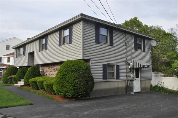 26 Mansfield Drive Wakefield, MA 01880 - Photo 26 of 26 a front view of a house with a garage