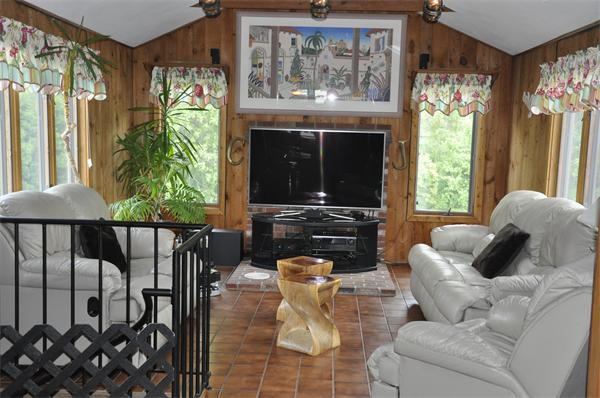 26 Mansfield Drive Wakefield, MA 01880 - Photo 6 of 26 a living room with furniture a fireplace and a floor to ceiling window