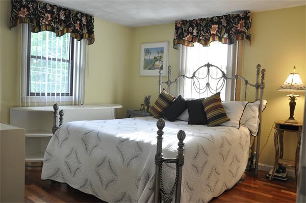26 Mansfield Drive Wakefield, MA 01880 - Photo 10 of 26 a bed sitting in a bedroom next to a window
