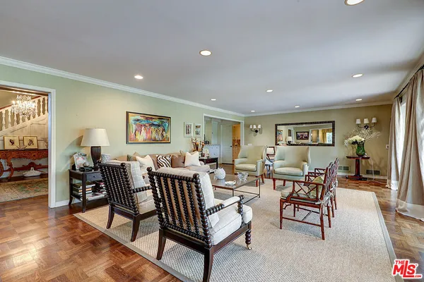 a kitchen with stainless steel appliances granite countertop a stove top oven a sink dishwasher a dining table and chairs with wooden floor
