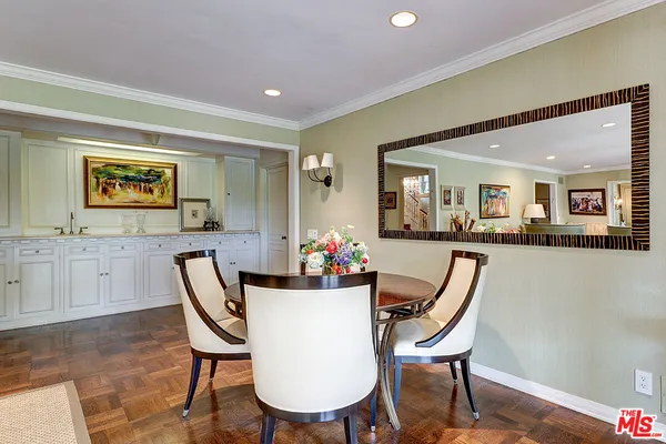 a living room with furniture and large windows