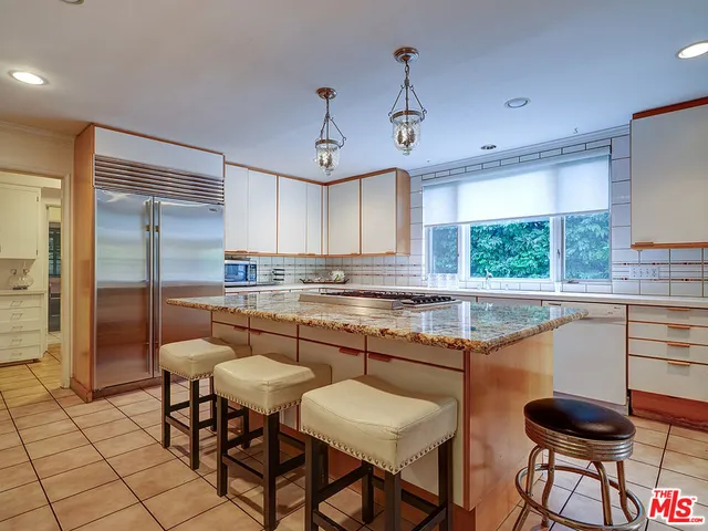 a spacious bedroom with a bed and large windows