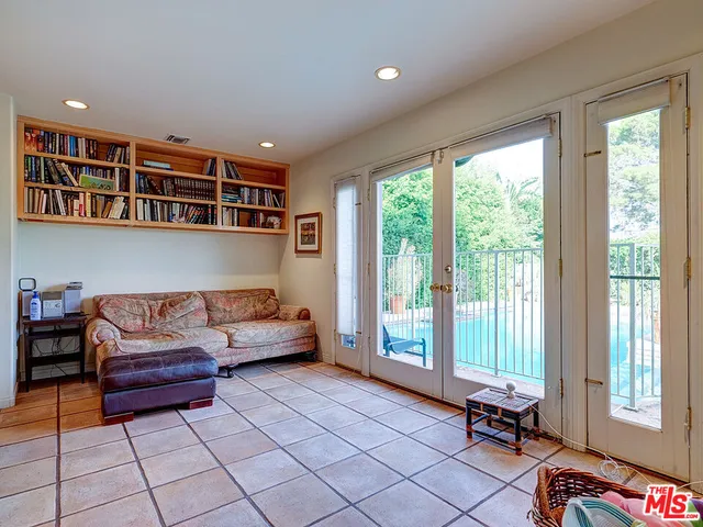 a bedroom with furniture and a large window