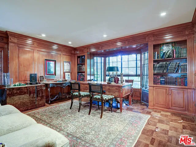 a bed room with furniture and paintings on the wall