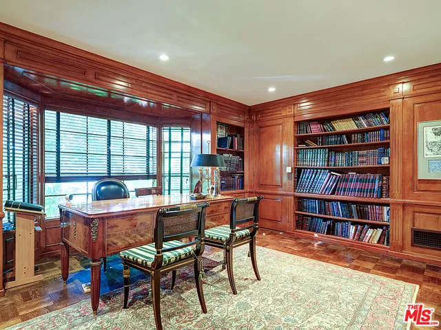 a view of a patio with table and chairs potted plants and palm trees