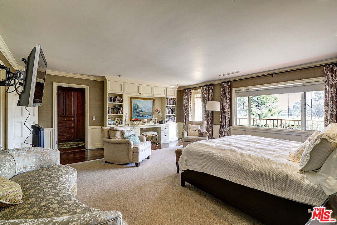 322 North June Street Los Angeles, CA 90004 - Photo 21 of 36 a bedroom with a balcony a large bed and a couch