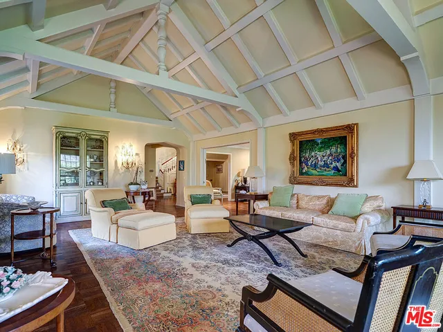 a living room with furniture and large windows
