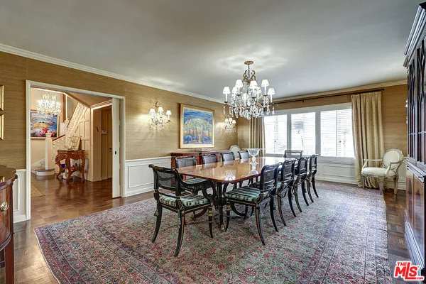 a view of a dining room with furniture and chandelier