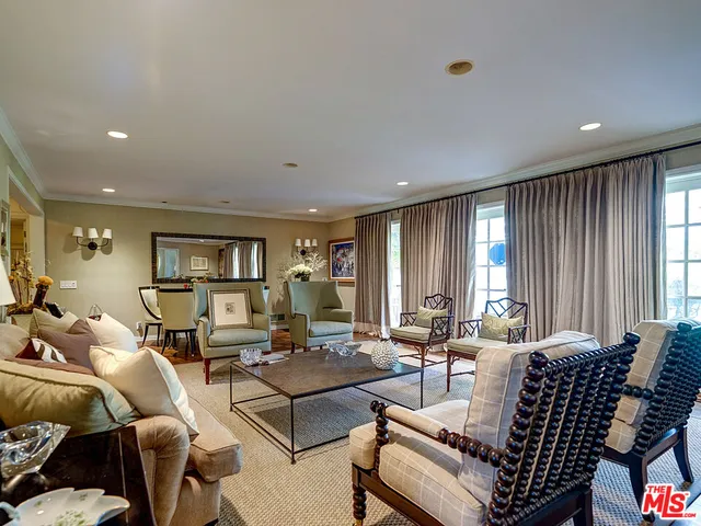 a view of a dining room with furniture a chandelier and wooden floor